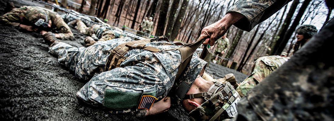 Soldier crawls through the mud