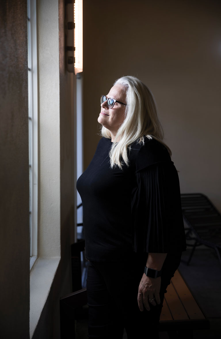 Pamela Neeleman by a window