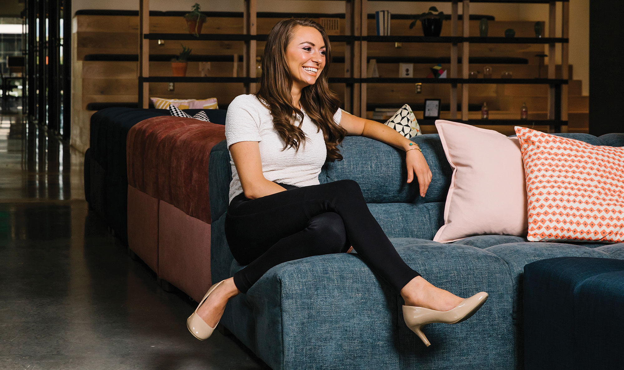 Female Wolverine Fund student sitting on blue couch