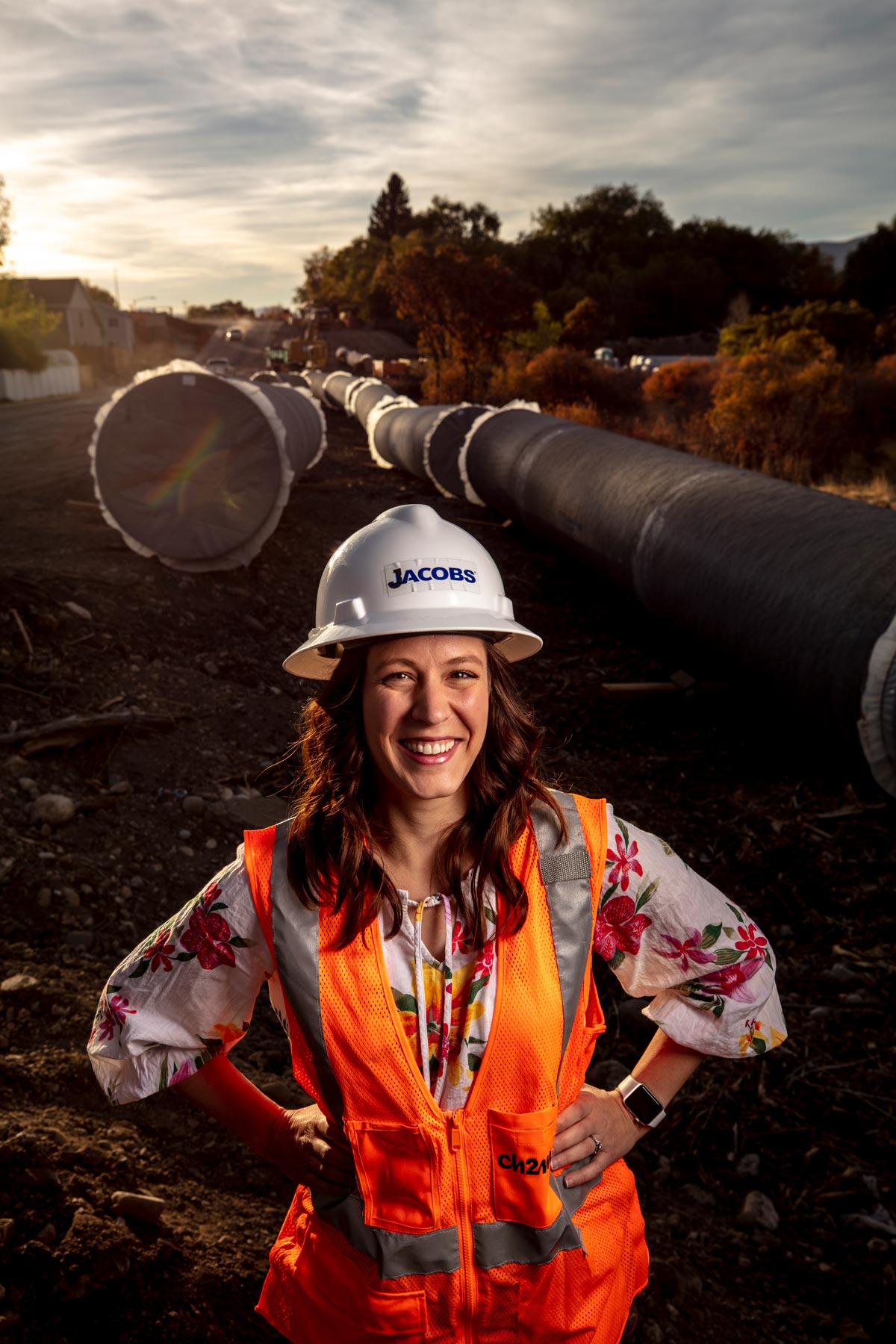 Julie Hansen poses for pictures on a water pipeline construction project in Payson, Utah