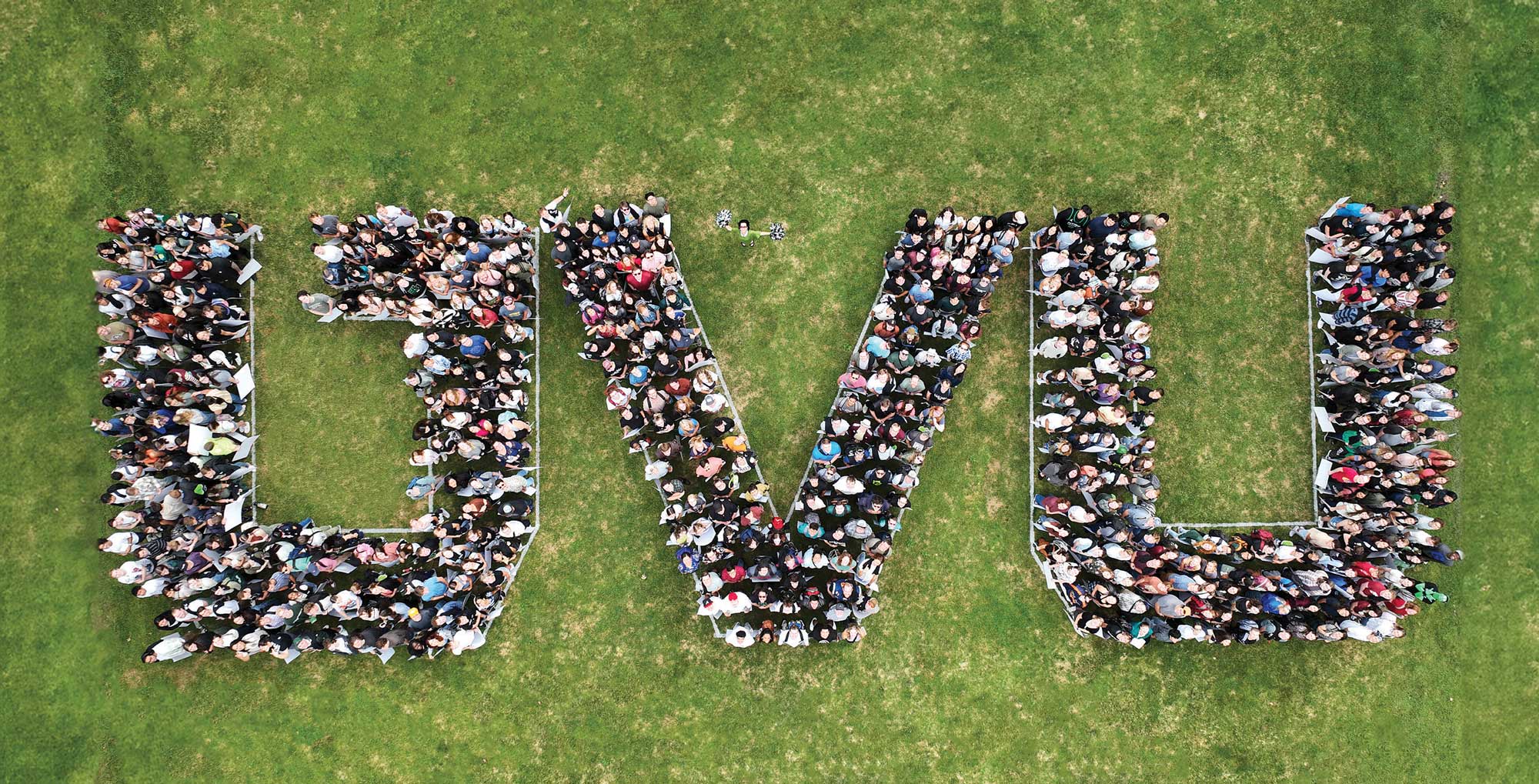 Aerial photo of people creating the letters UVU