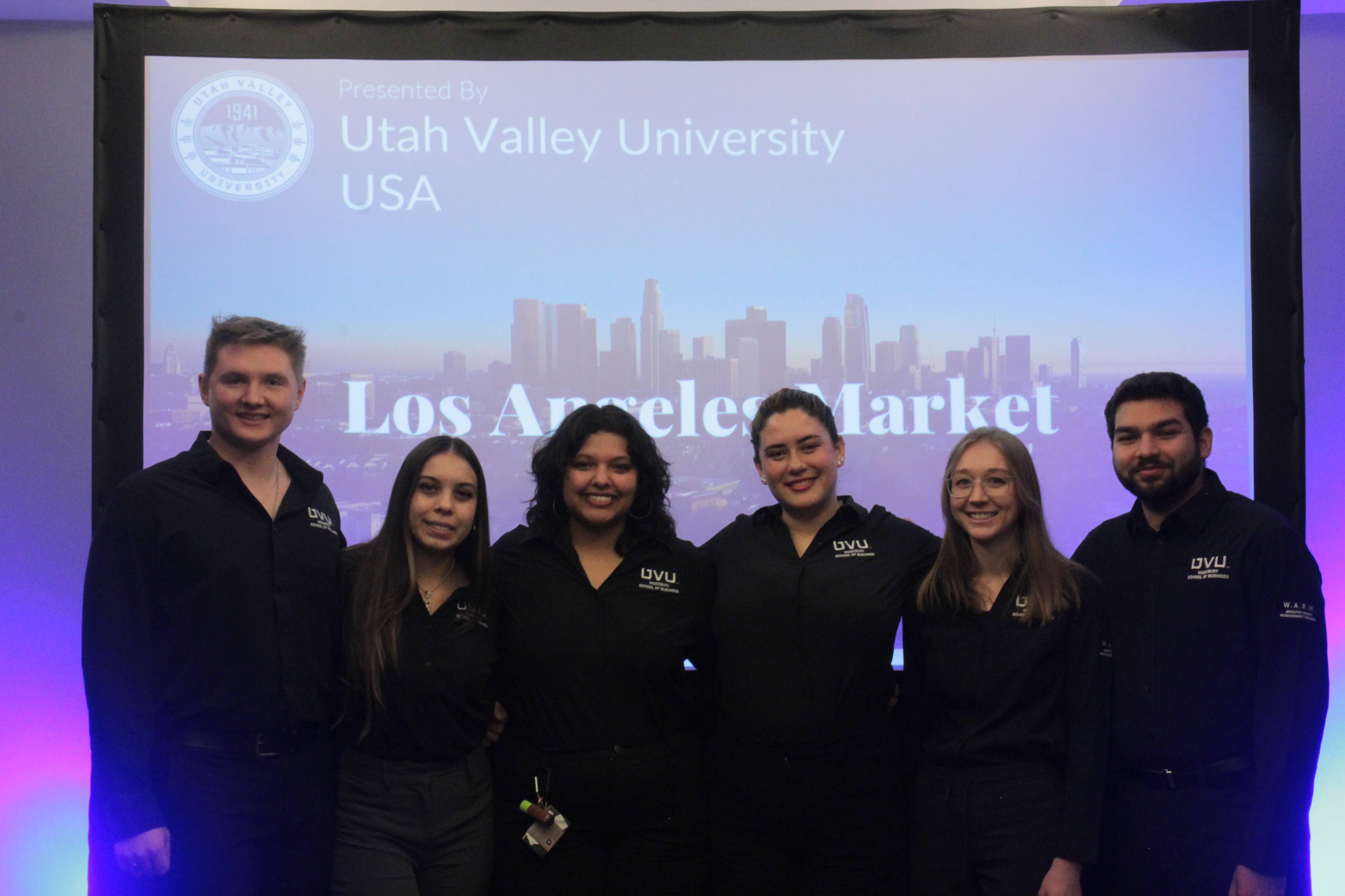 Winning team of WARM students pose in front of their presentation