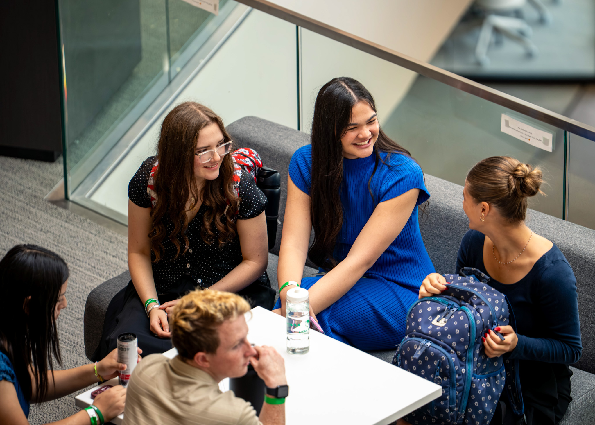 A group of students sharing a conversation during the Alan Hall Marketing and Sales Invitational event hosted in the Scott C. Keller Business Building.