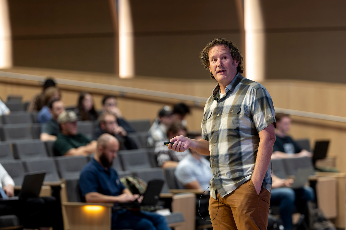 Brian Fruit presents on stage at UVU’s Keller Building, sharing stories of building Lizard Skins into a global brand.