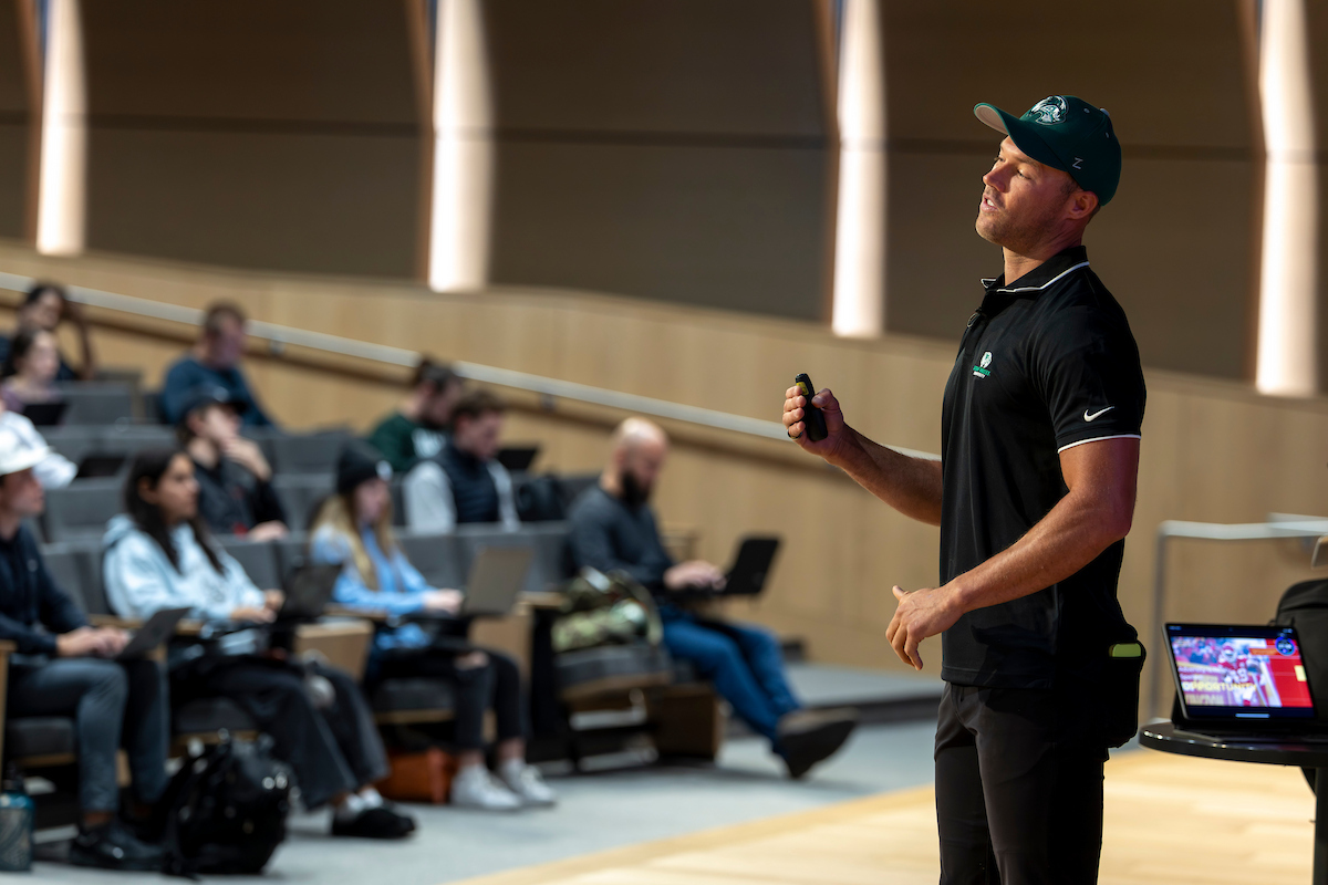 Daniel Sorensen stands on stage at UVU’s Keller Building, delivering his talk “Overcoming Adversity in Life and Sport."