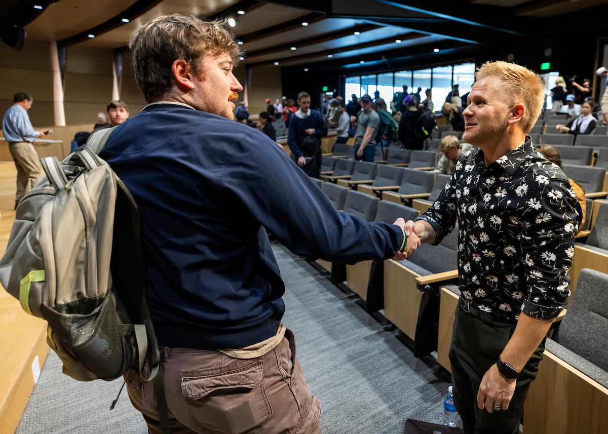 Clint Pulver shaking hands with a student after the lecture.