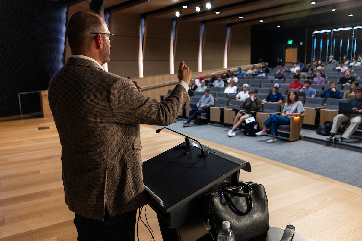 Brad Bonham addresses students from the stage podium during his Halladay Lecture Series talk.