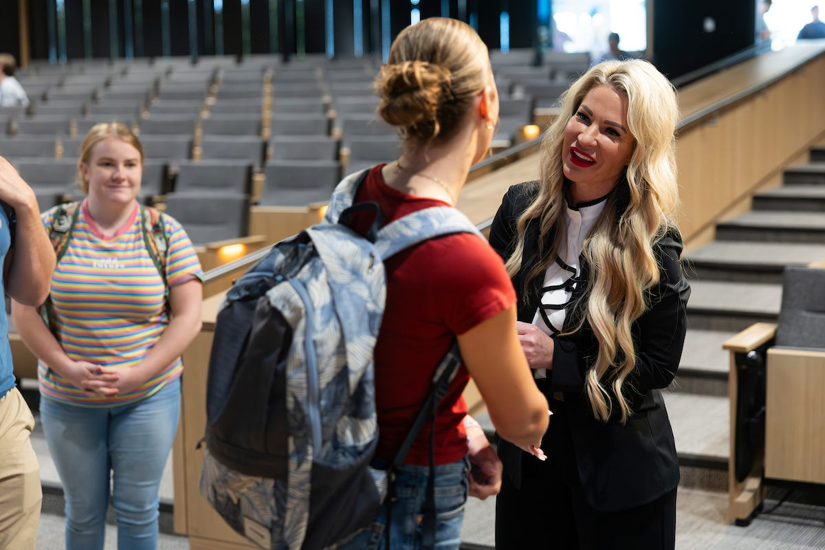 Rachelle Rutherford talks with a student after her lecture at UVU, following an emotional and inspiring discussion on resilience and purpose.