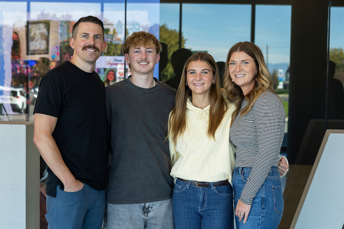 Taylor Napierski poses with his family inside UVU’s Keller Building after his Halladay Lecture Series presentation.