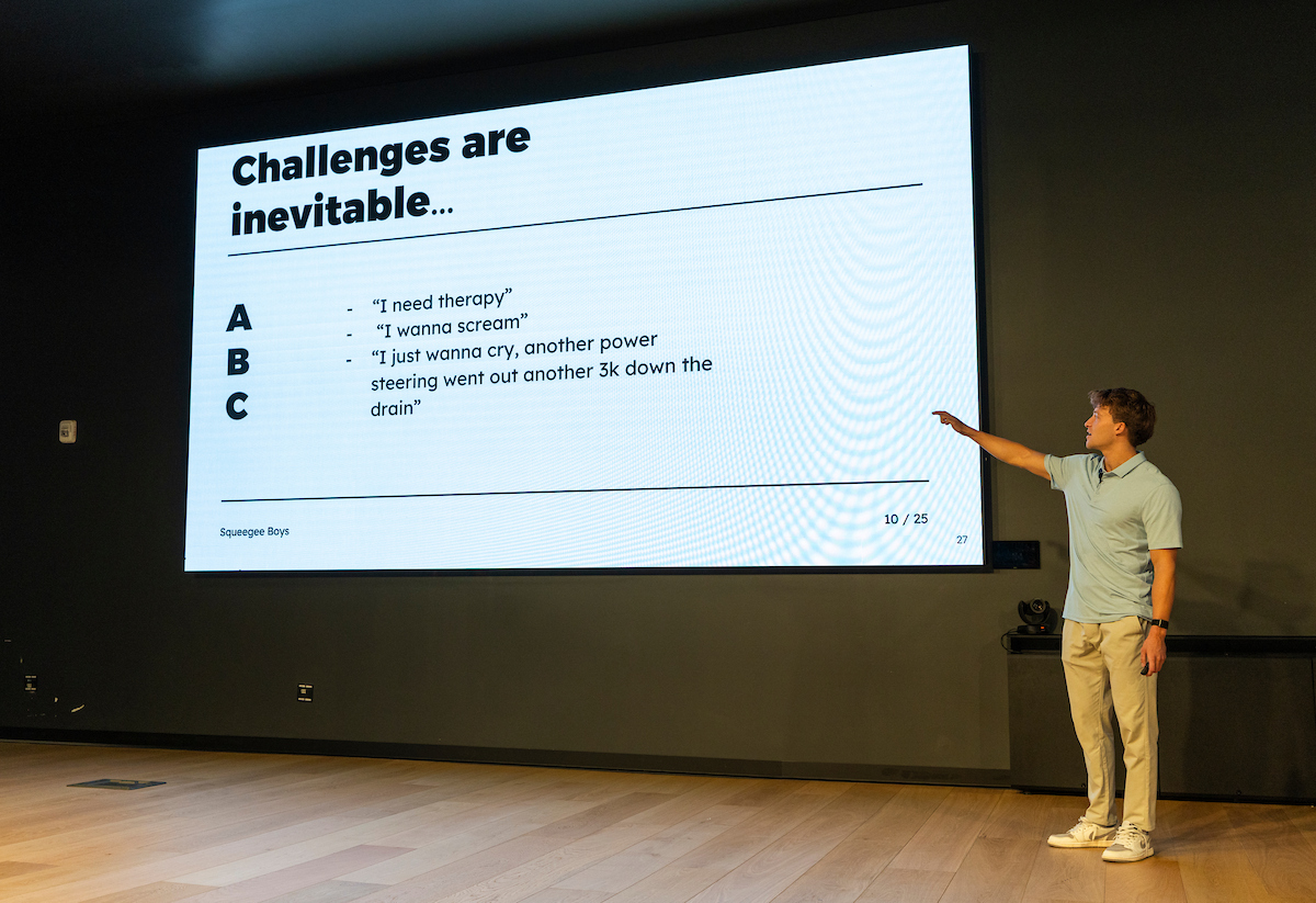 Casey Brown presents a slide titled “Challenges Are Inevitable,” sharing lessons on perseverance and resilience with UVU students.