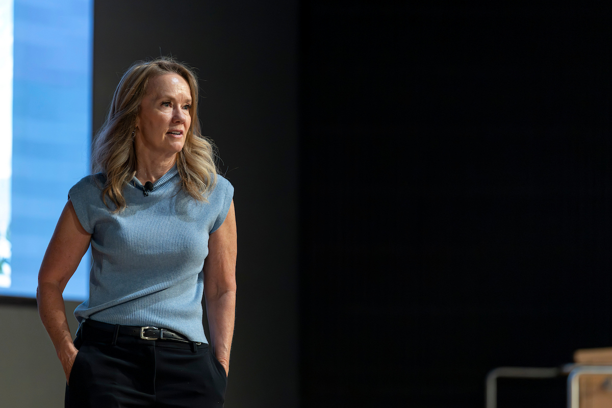 Shannan Busby stands onstage with her hands tucked in her pockets as she listens to an audience member during the Q&A session following her lecture at the Reed and Christine Halladay Executive Lecture Series.
