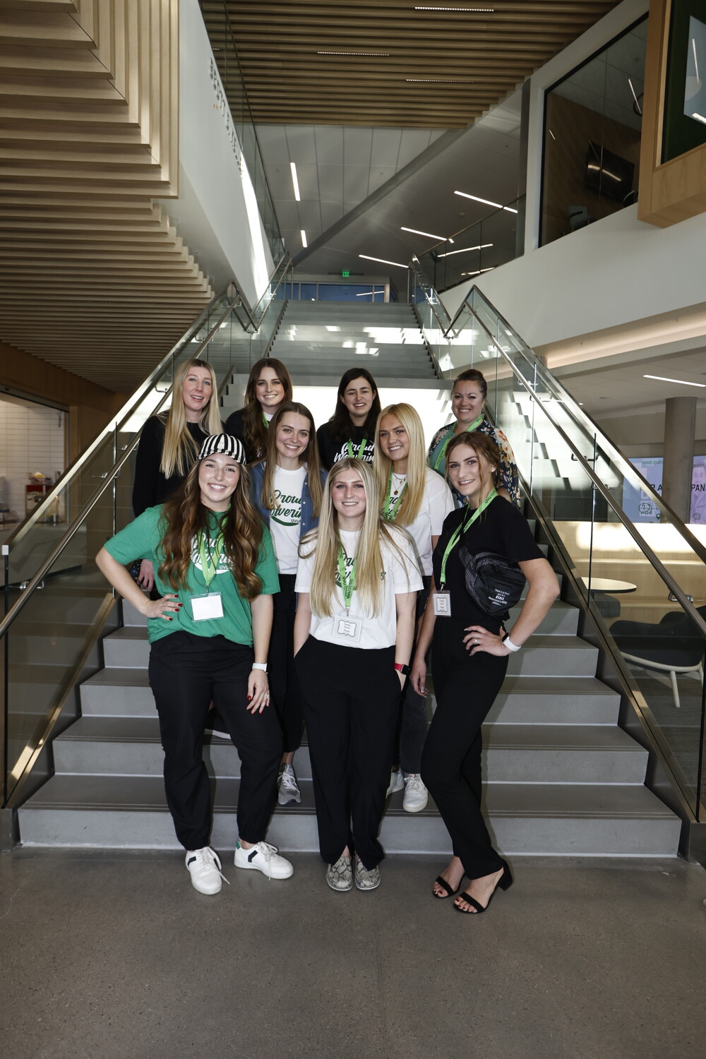 A group of UVU's event management students stand in front of staircase