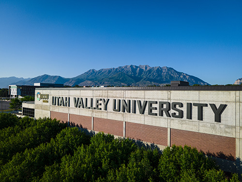 Utah Valley University signage on a building with a mountain in the background