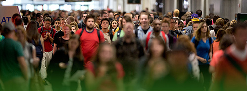 Hundreds of students walking through the hall