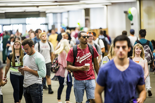 Hundreds of students walking through the hall