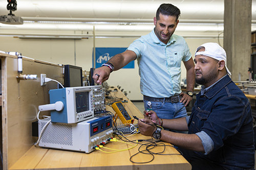 Two people working on electronics