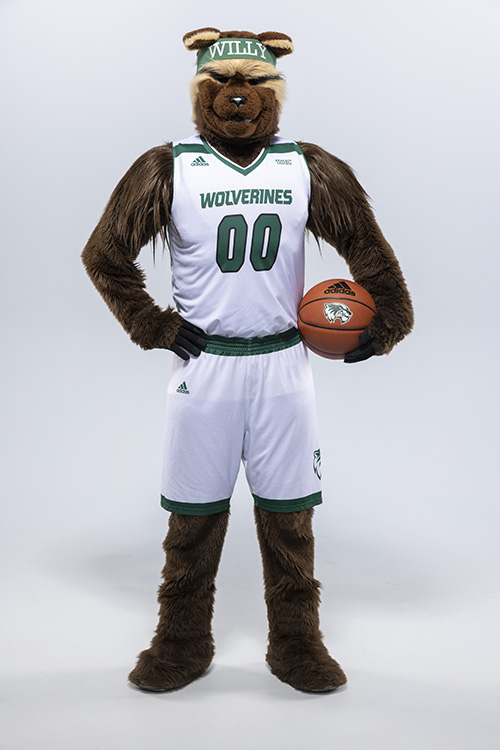 Willy the Wolverine wearing a white basketball uniform and holding a basketball