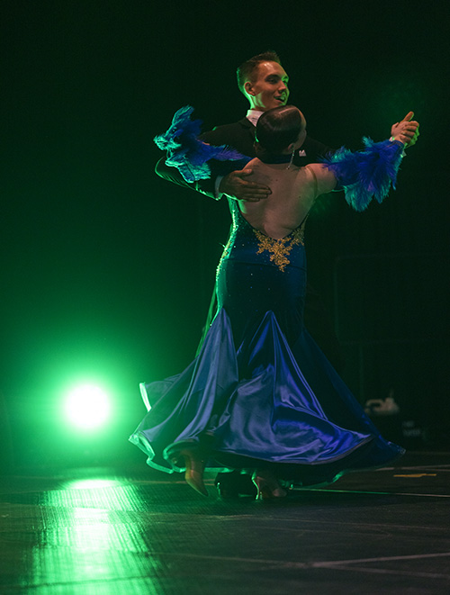 Ballroom dance couple with green spotlight.