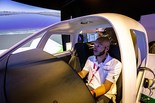 Aviation student in flight simulator.