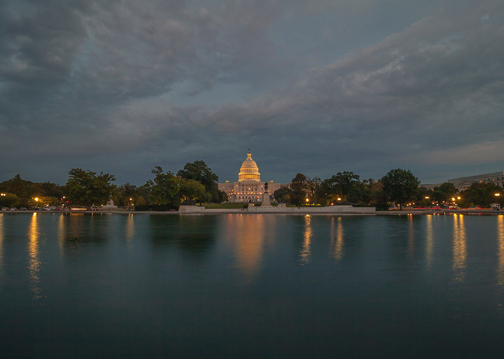 Capitol Building at night over the water.