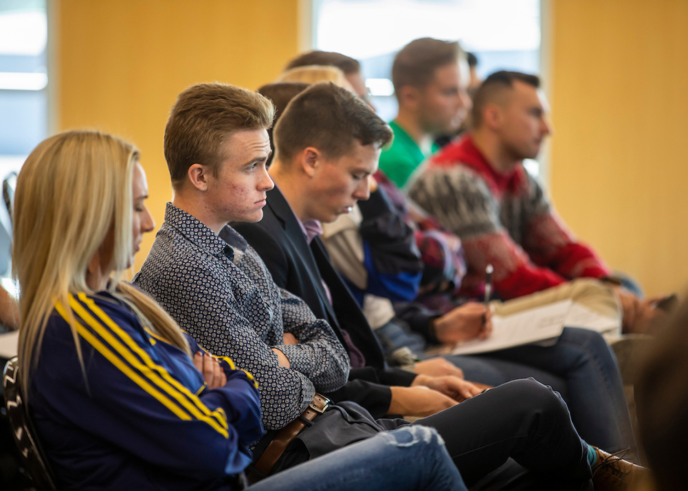 New view of a Group seated and listening during a talk.