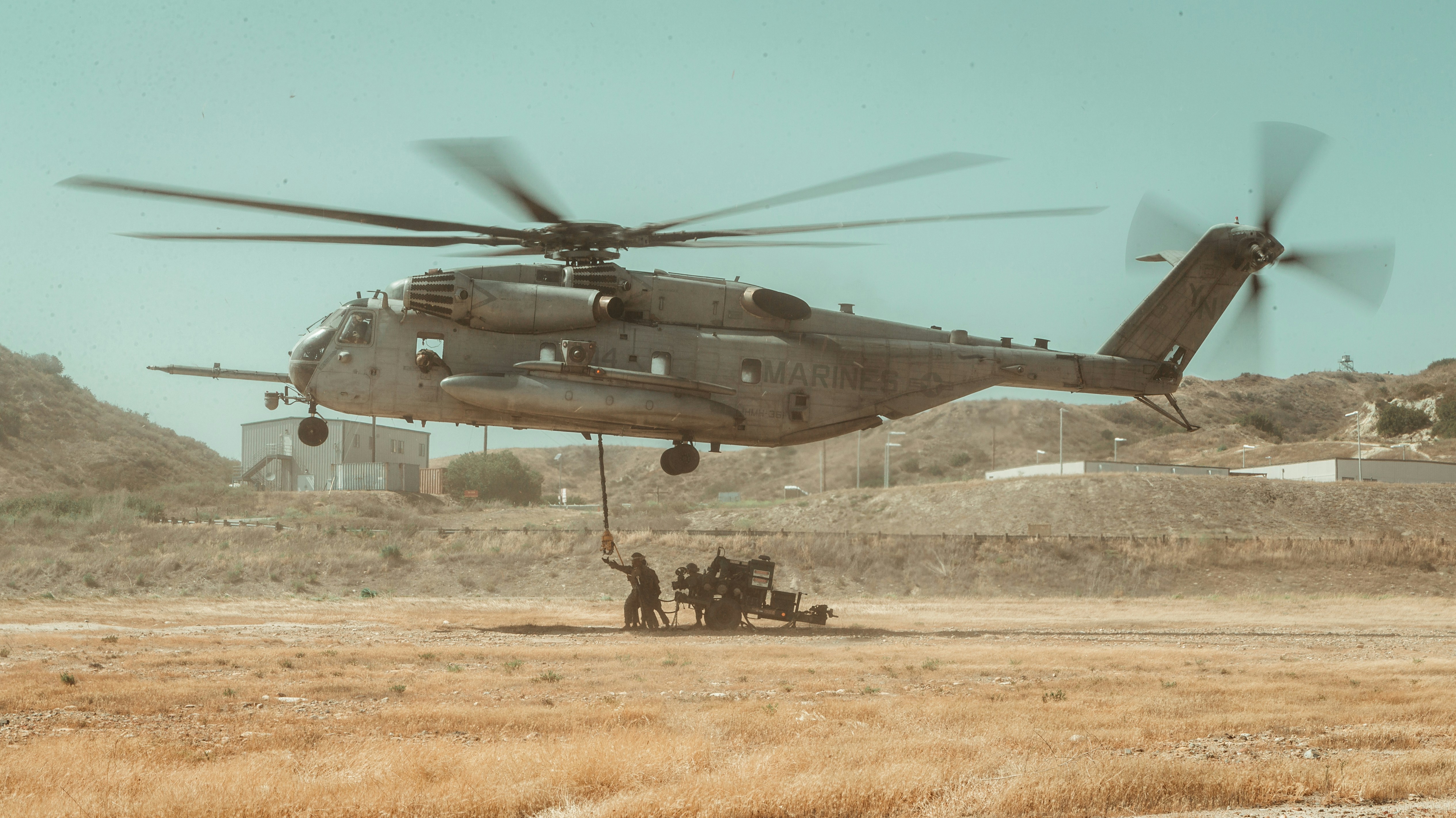 Helicopter with people under it
