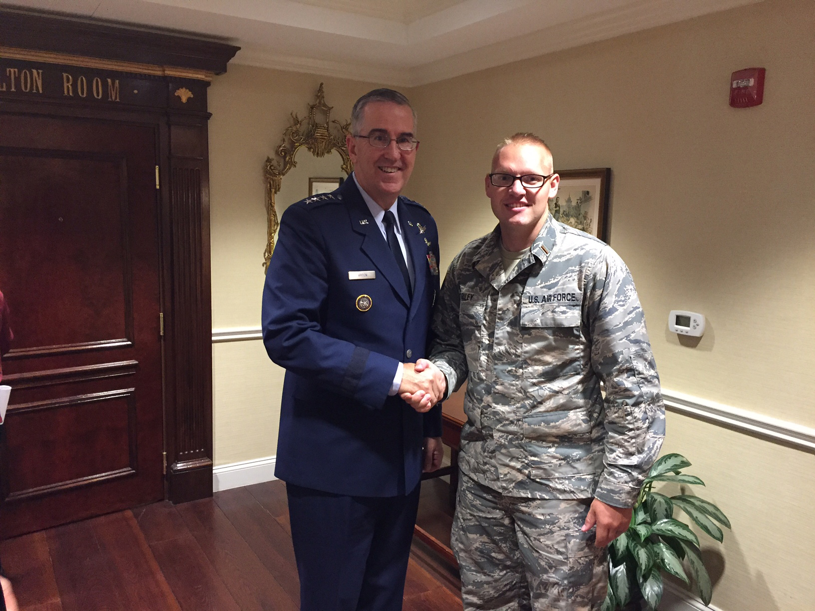 General shaking hands with a new recruit.