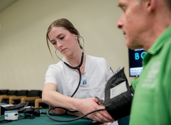 woman measures a man's blood pressure