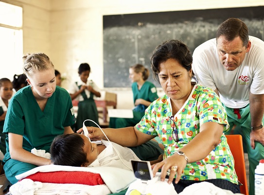 a woman looks at a small ultrasound scan