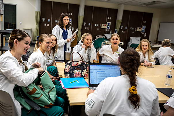 nurses around a table laughing