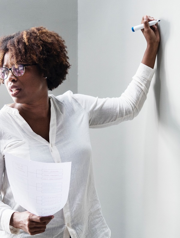 woman writing on whiteboard