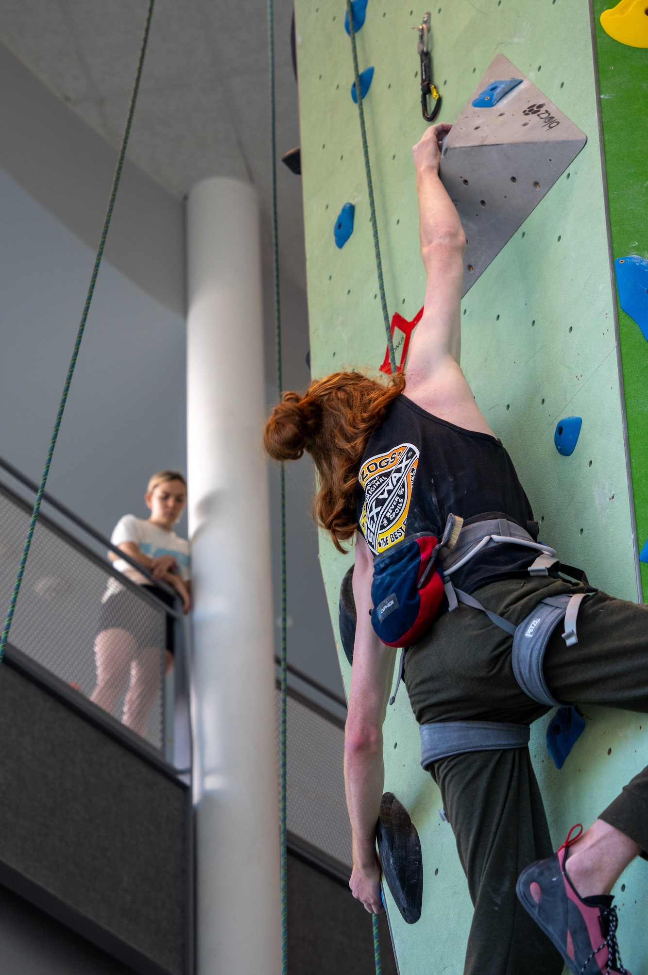 Person on an indoor rock wall lead climbing