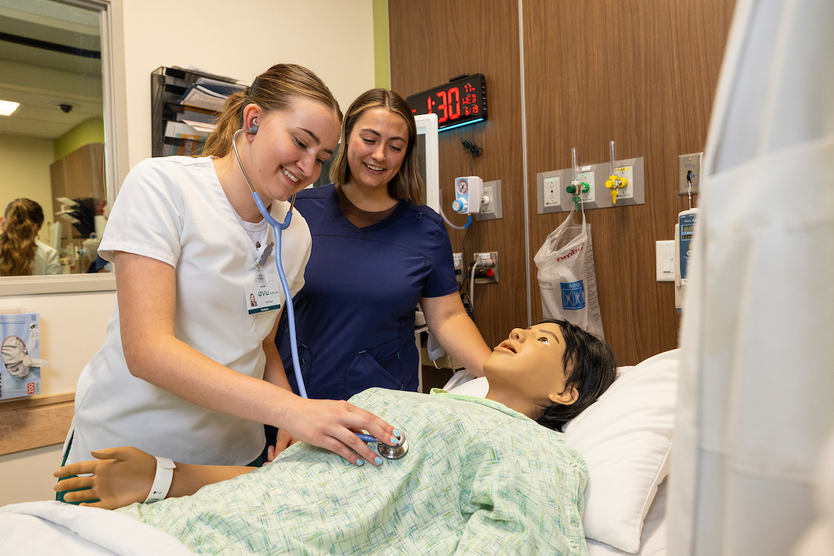 nursing student helping in a hospital room