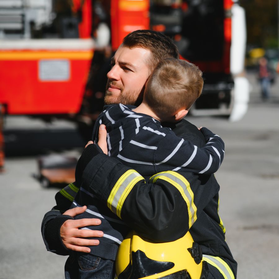 EMT hugging a child