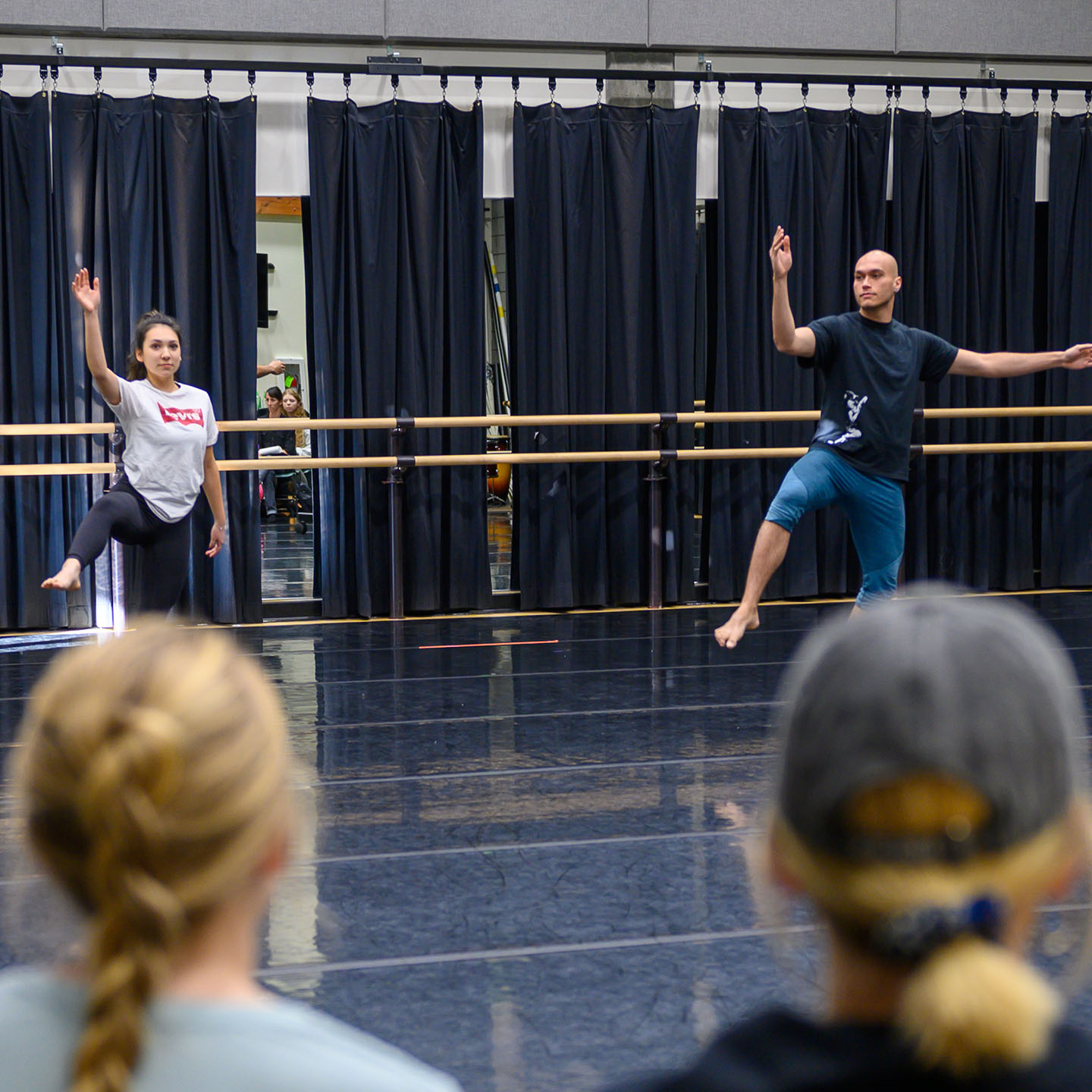 Female dancer and male dancer perform in dance studio