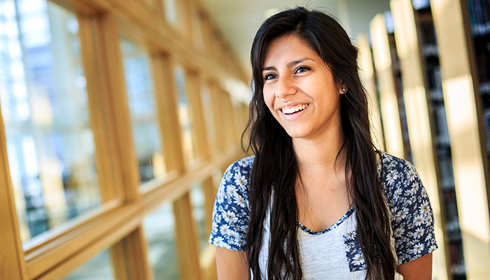 student standing in library