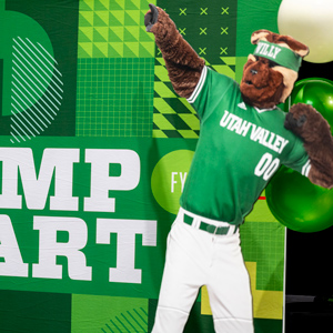 Willy the Wolverine stricking a pose in front of a backdrop with 'Jump Start' written on it.