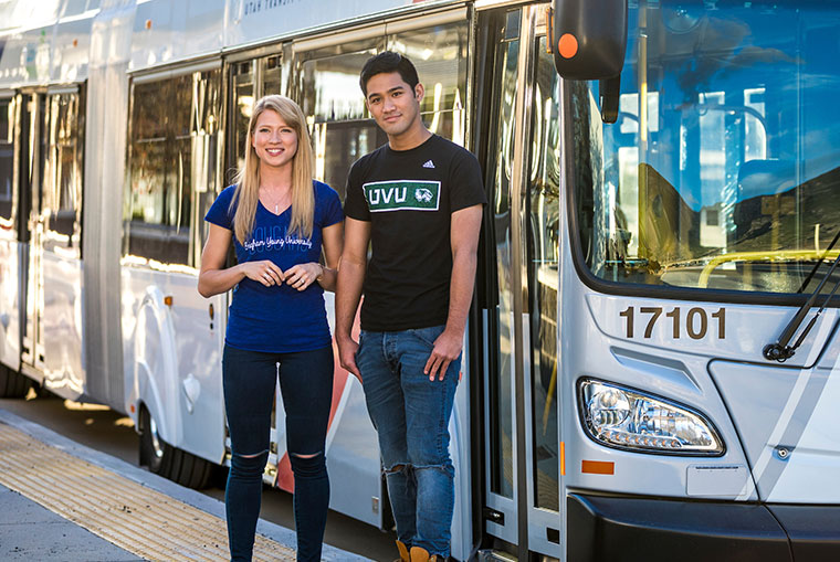 A male and female student standing in front of UVX