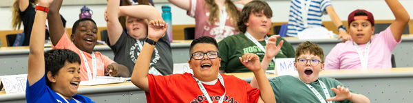A UVU PREP student raising his hand in a class to ask a question