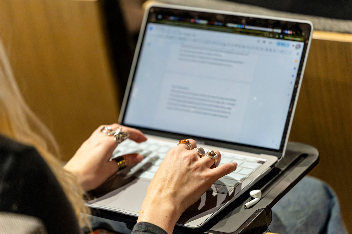person typing on their laptop