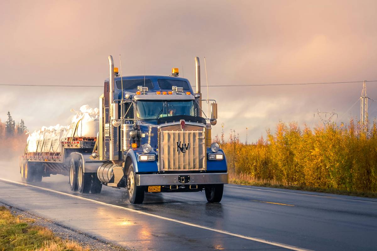 blue semi-truck on the road