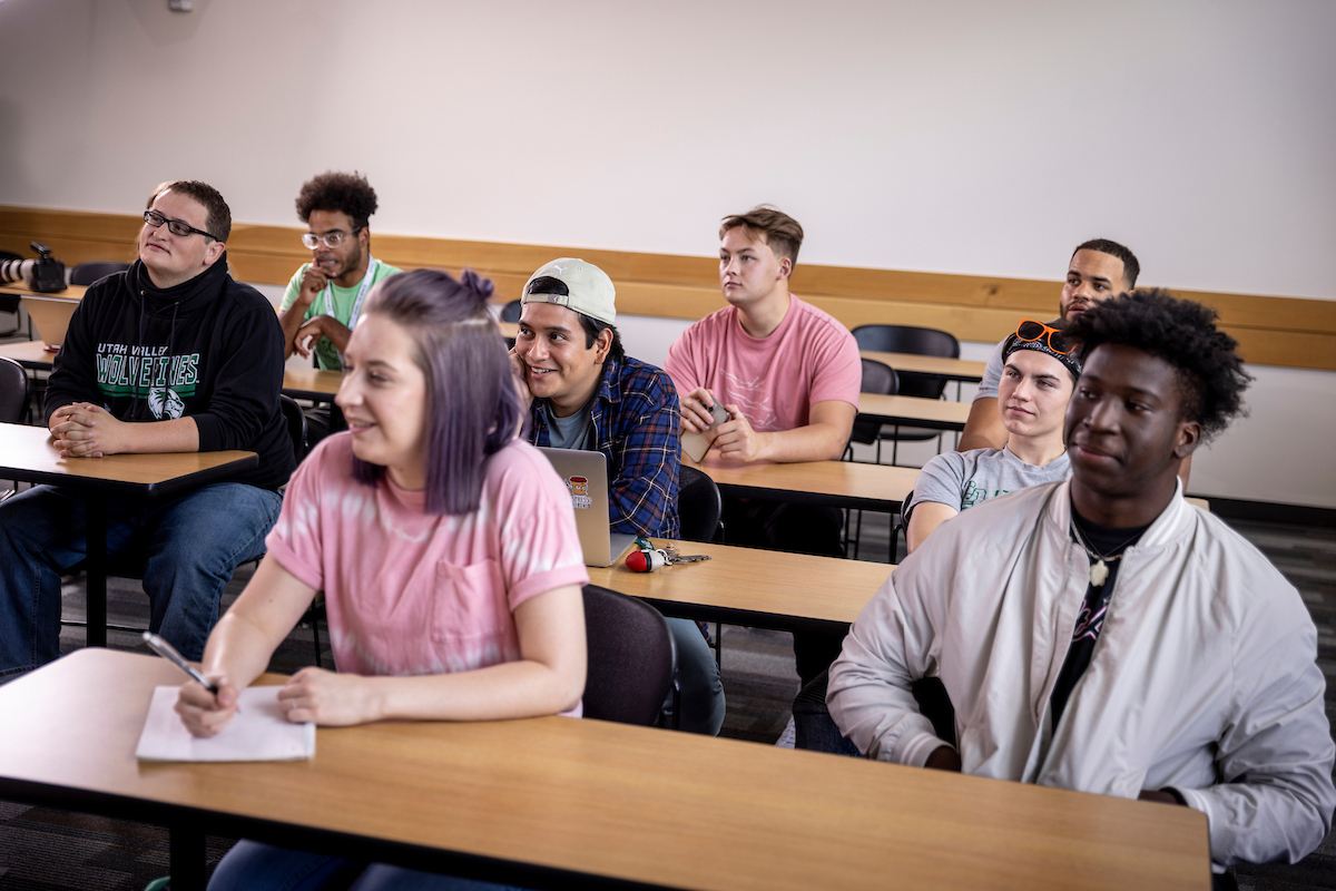Group of students sitting in desks in a classroom.