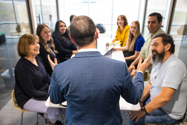 People having a discussion around a table