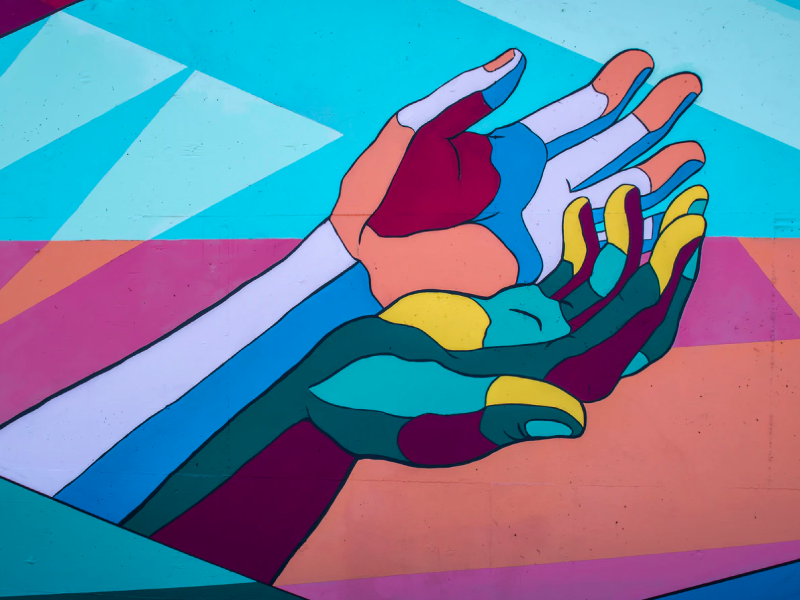 A colorful painting of two hands