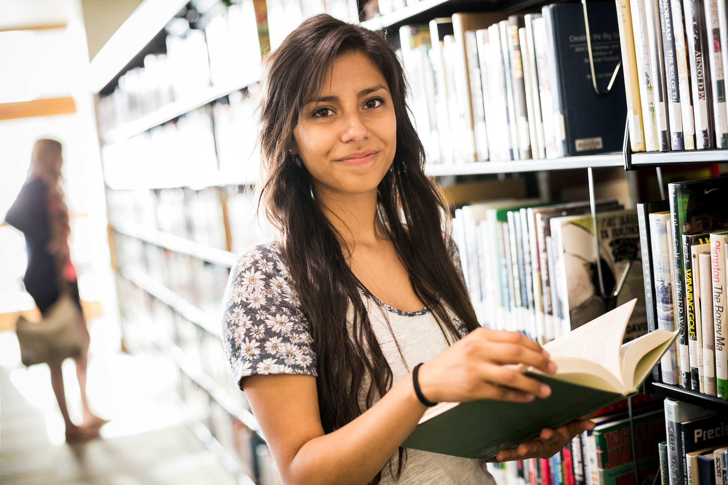 Student in the Library holding a book