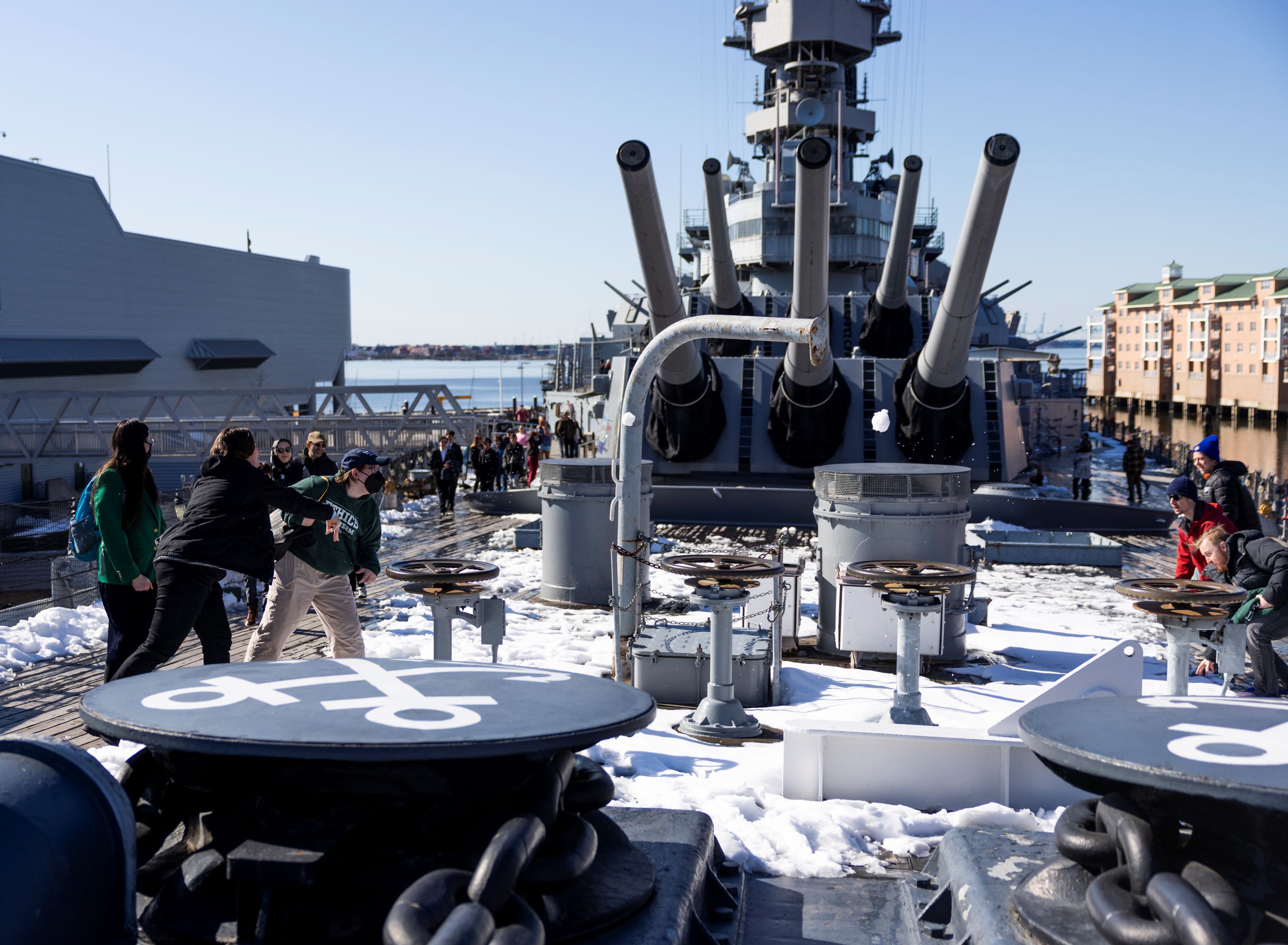 the uvu team in a spontanious snowball fight abord the uss cumberland