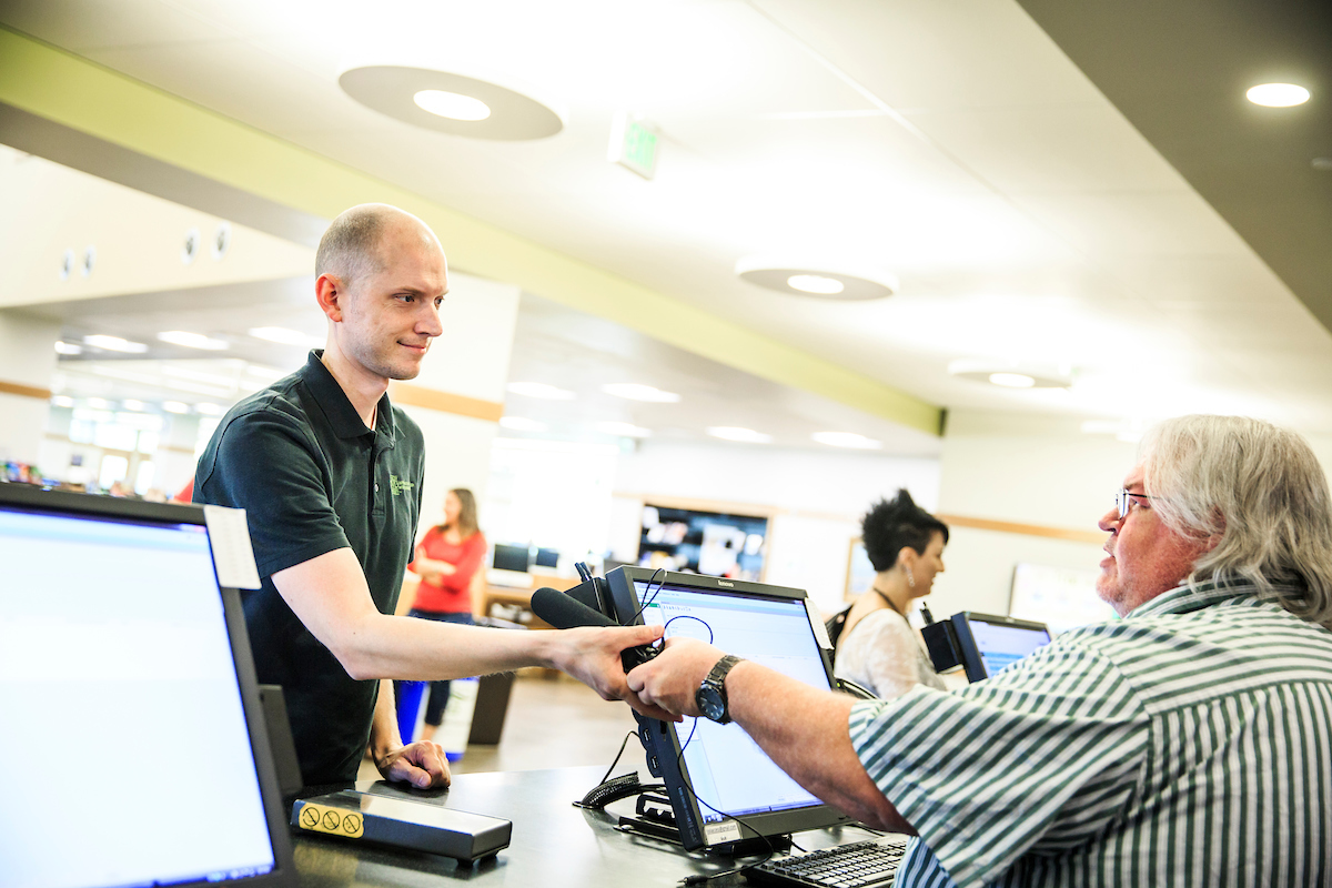 Image of a person talking to a library worker