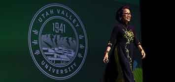 President Tuminez walking across a stage