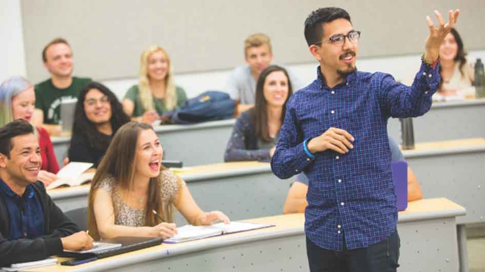 Classroom setting with teacher in the front of the classroom