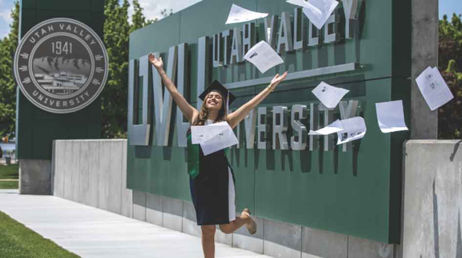 Graduating student throwing papers in the air in celebration